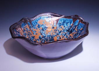 Side view handmade basin sink with wavey bent edge nickel crystal glazed inside, purple shock outside, oilspot lip